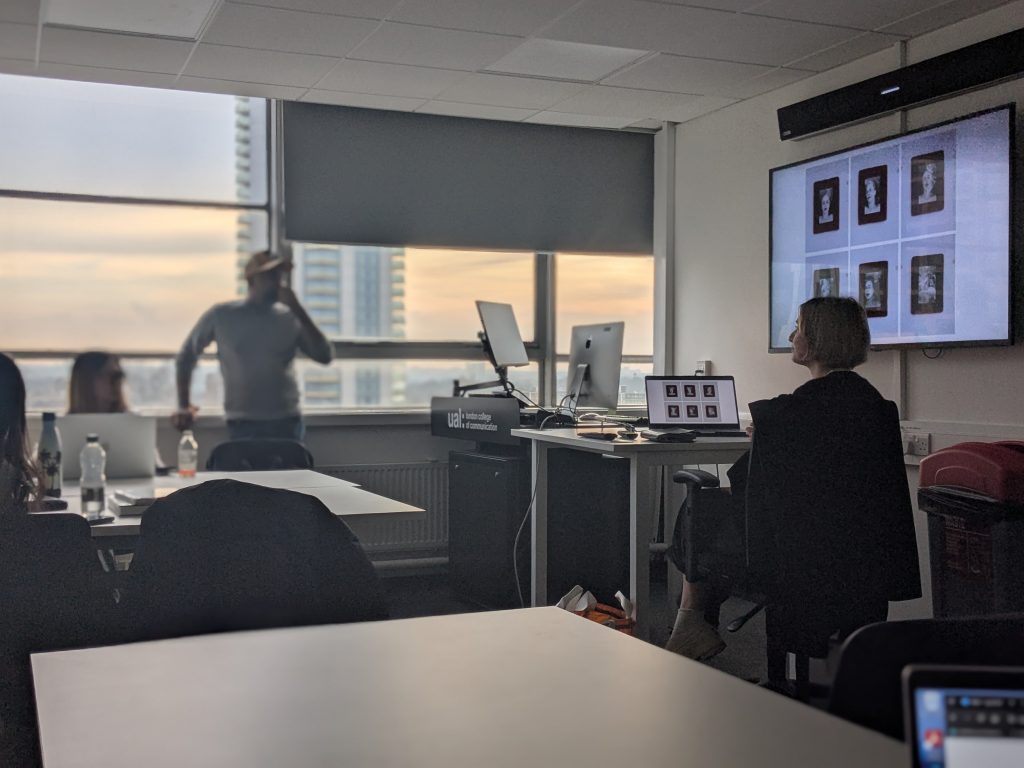 Classroom setting. Artist showing presentation of photographic work on a projection screen